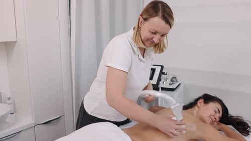Woman Receiving Back Massage in Medical Office