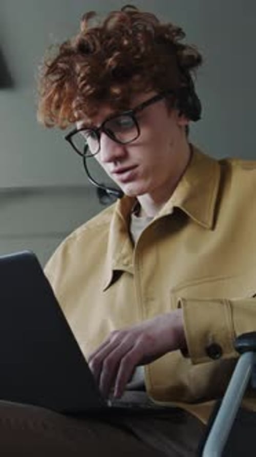 Call Center Operator in Wheelchair Using Laptop during Online Call