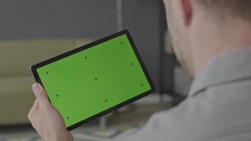 Man Using Digital Tablet with Green Screen