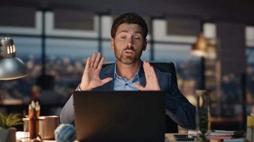 Man Gesturing in Office During Video Conference