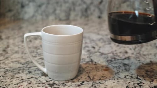 Fresh Coffee Poured into White Mug in Kitchen