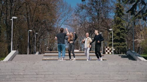 Friends Dancing Together in an Urban Park