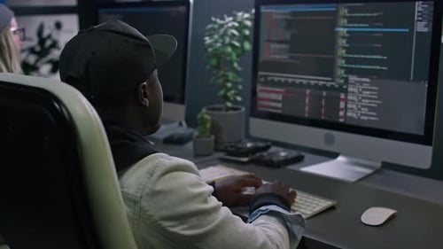 African American Male Programmer Writing and Testing Computer Code