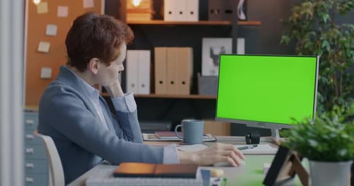 Ambitious Businesswoman Speaking to Client on Mobile Phone and Looking at Chroma Key Green Screen
