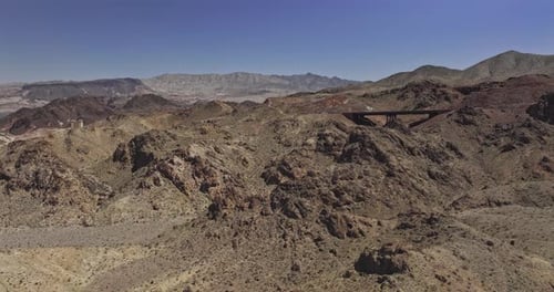 Lake Mead Nevada Aerial v11 flyover terrain capturing a highway curves through a rugged, arid