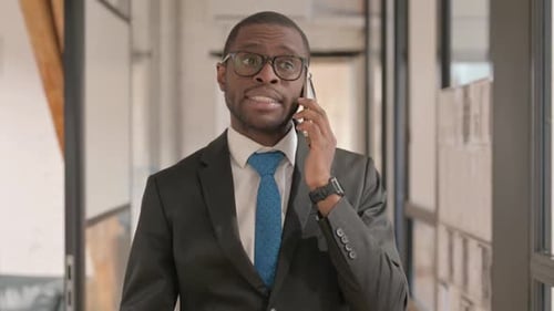 Businessman Talking on Phone in Modern Office