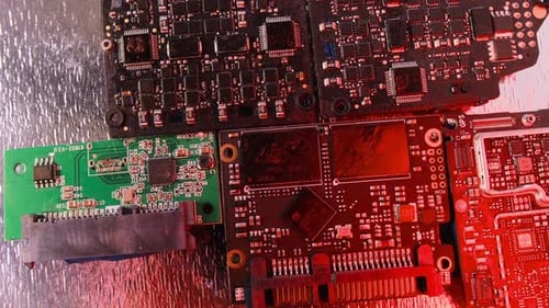 Close up, microchips in alarming flashing lights on rotating table. Circuit board surface. CPU