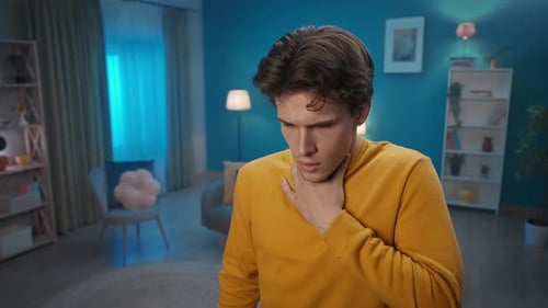 A Man Uses an Asthma Inhaler in the Living Room at Home Close Up A Man Takes Out an Inhaler From His