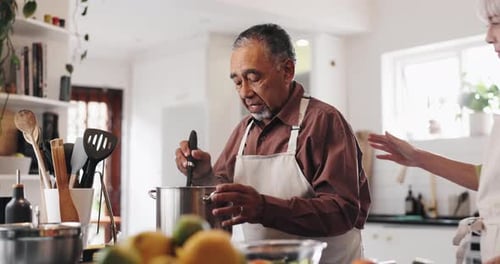 Elderly Couple Cooking Food Together in Kitchen