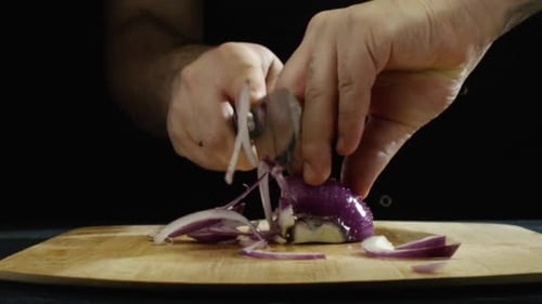Slicing fresh red onion with knife
