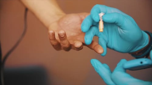 Doctor measures blood glucose level with a glucometer. Express diagnosis of diabetes in the clinic.