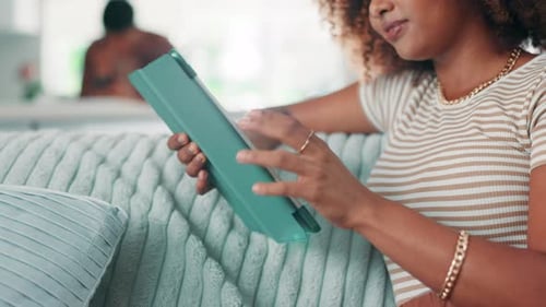 Woman Using Tablet on Couch at Home