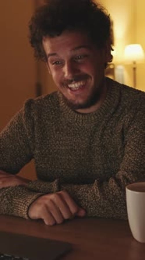 Cheerful Young Man Video Chatting from Home