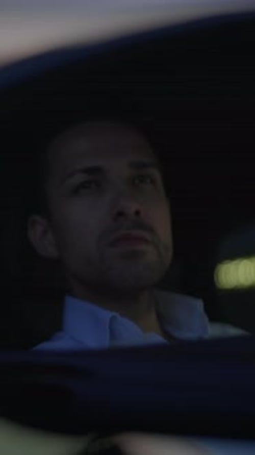 Man's Reflection in Car Side Mirror at Night