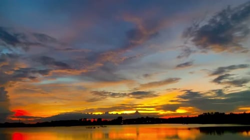 The beautiful sunset over the calm waters of the lake makes for a perfect view