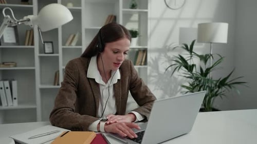 Woman Video Conferencing in White Modern Office Setting