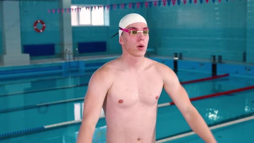 Swimmer Stretching Before Exercise in Indoor Pool