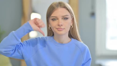 Portrait of Woman showing Thumbs Down