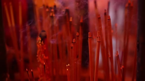 Incense Sticks Burning in Darkened Room Creates Smoke