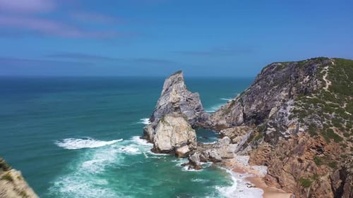 Ursa Beach Cliffs and Atlantic Ocean Waves on Sunny Day Portugal Aerial View