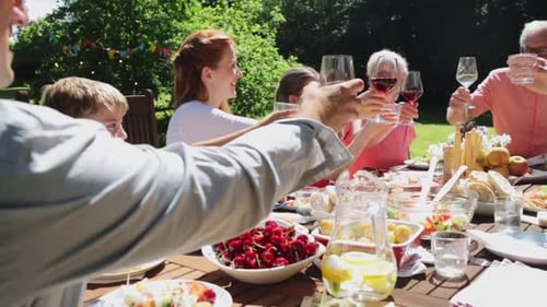 Happy family celebrates summer holidays with festive garden party feast together