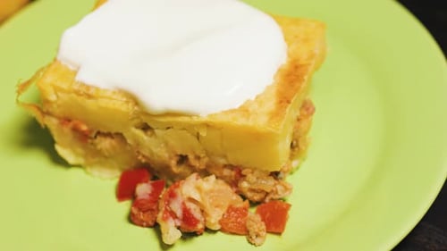 Potato and Meat Casserole Garnished with Sour Cream Close Up