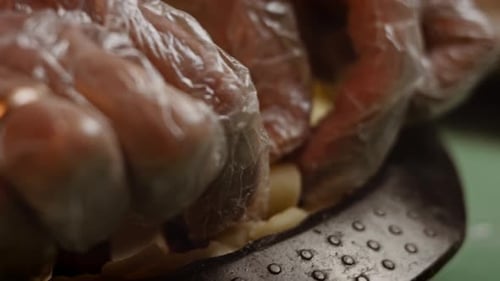 Gloved Hands Placing Crust on Homemade Pie