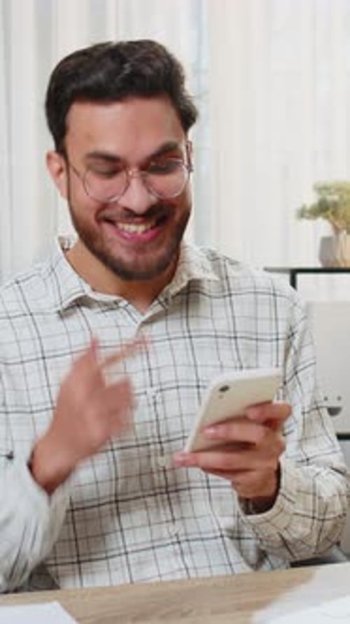 Happy Indian Businessman Using Smartphone Celebrating Success Victory Winning Lottery Casino Jackpot