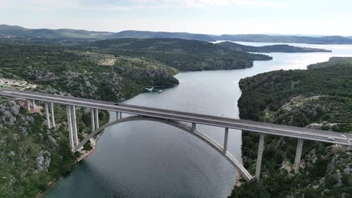 Drone flight above a beautiful arch bridge near the town of Shibenik in Croatia