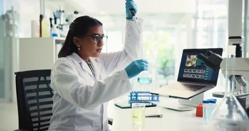 Scientist mixes chemicals in lab for research