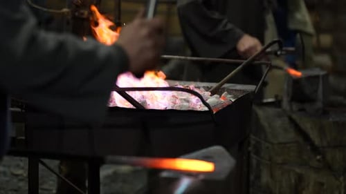 Blacksmiths Working with Fiery Metal in Workshop
