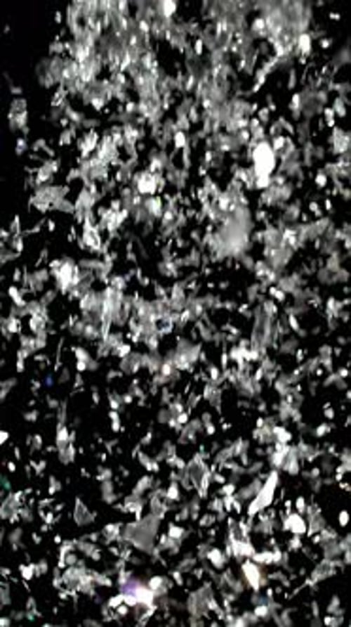 Falling Silver Confetti on a Black Background