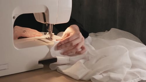 Closeup Shot of Sewing Machine Sews a Line a Seamstress Woman Cuts Off a Thread