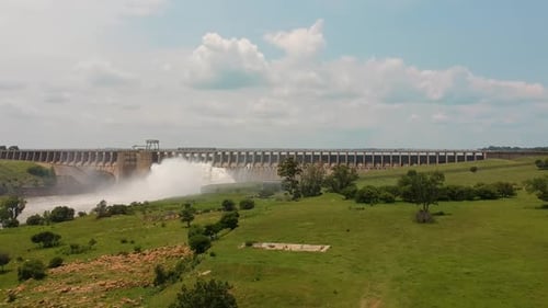 Dam reservoir with sluice gates releasing water, Engineering, infrastructure.