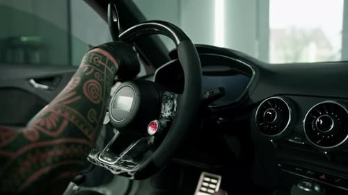 Worker cleans steering wheel professional brush and clout of microfiber Professional car wash