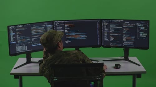 Bored Asian Man Soldier Developer Write Code With Multiple Computer Screens In Green Screen