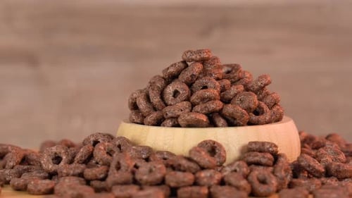 Delicious Chocolate Cereal Loops Overflowing from Wooden Bowl