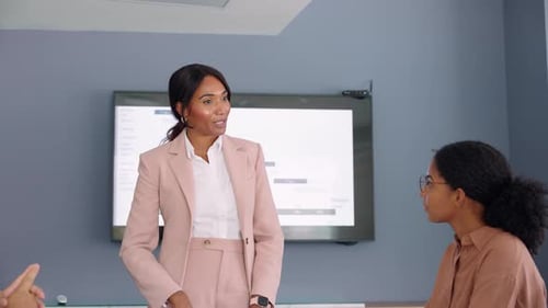 Businesswoman Presenting to Colleagues in Modern Office