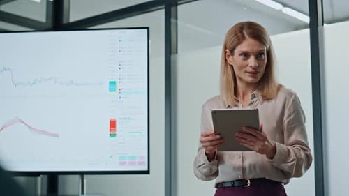 Woman Presenting Data in Modern Office Setting