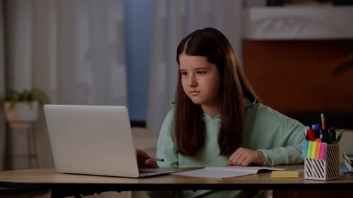 Girl Doing Homework with Laptop in Home Interior