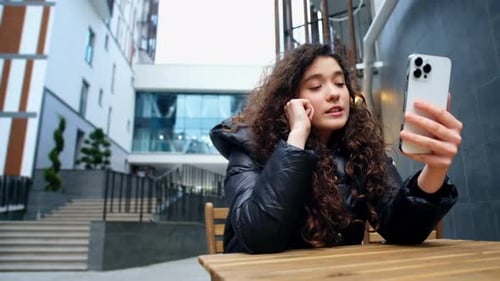Young Woman Video Chatting Outdoors