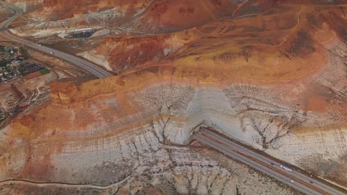 Highway in Wyoming going through the mountain. Little town hiding in the bare rocks. Aerial view.