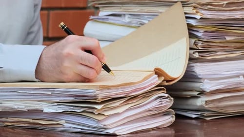 Hand Writes on Papers in Office Close-Up
