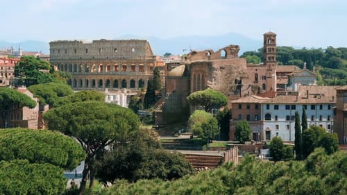 View of the ancient center of Rome, Italy. Colosseum visible in the distance, a lot of greenery