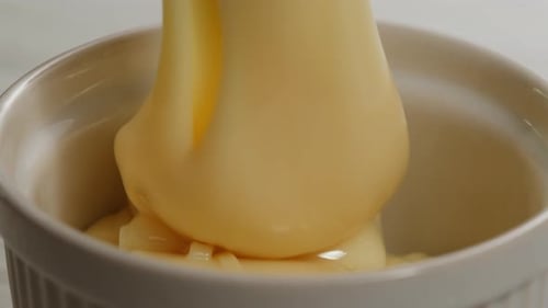 Tasty Condensed Milk Spoon and Waffles on Light Grey Table Flat Lay Space for Text