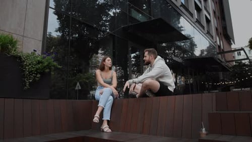 Young Couple Chatting on Urban Bench