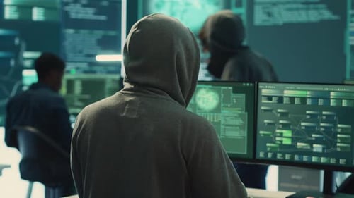 People Coding in Front of Multiple Monitors