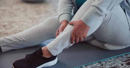 Injury, legs and person with cramp, massage and muscle tension from strain in gym, fitness or hurt