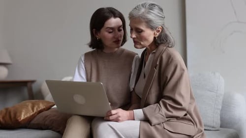 Women Work Together on Laptop Indoors