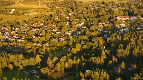 Aerial view at sunset of a small village Inčukalns in Sigulda Municipality, Latvia, house surrounded